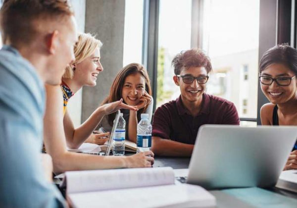 German course in a small group. The teacher and the participants are laughing.